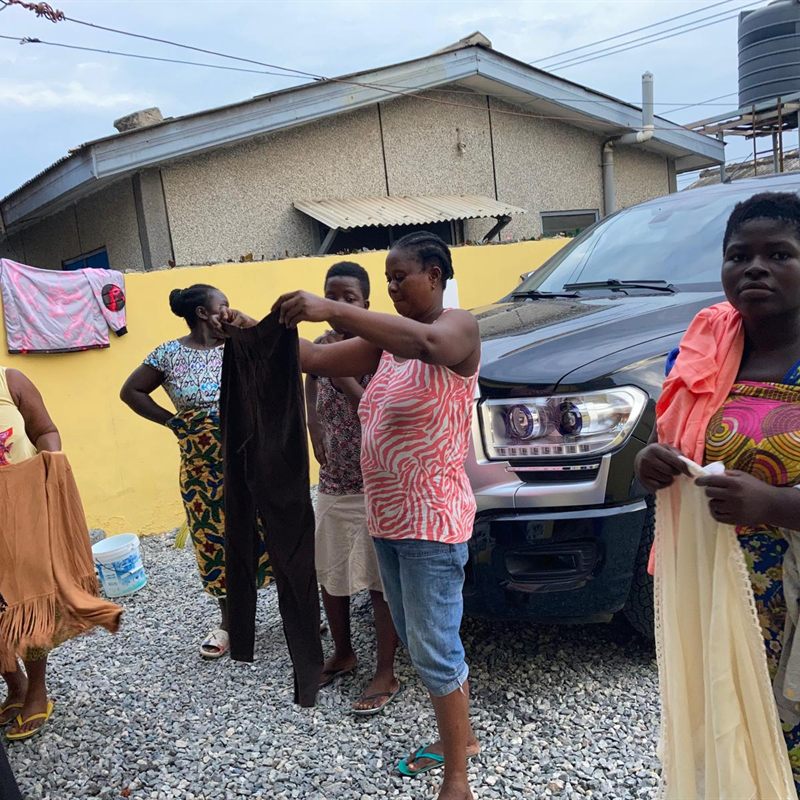 Women choosing from donated clothing at a community distribution